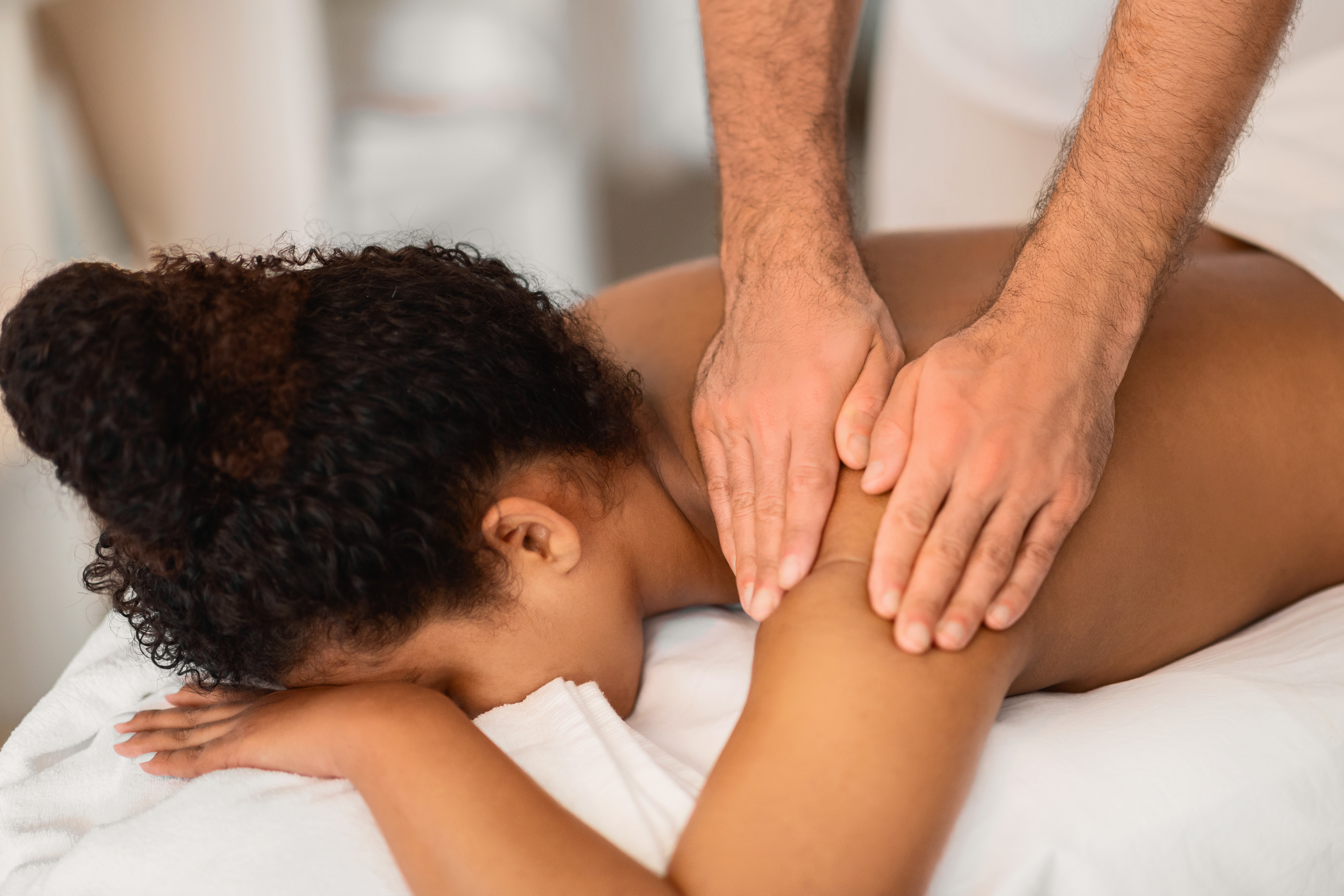 Woman relaxing professional massage treatment at home in Karachi